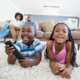 siblings-lying-rug-watching-television-living-room (1)